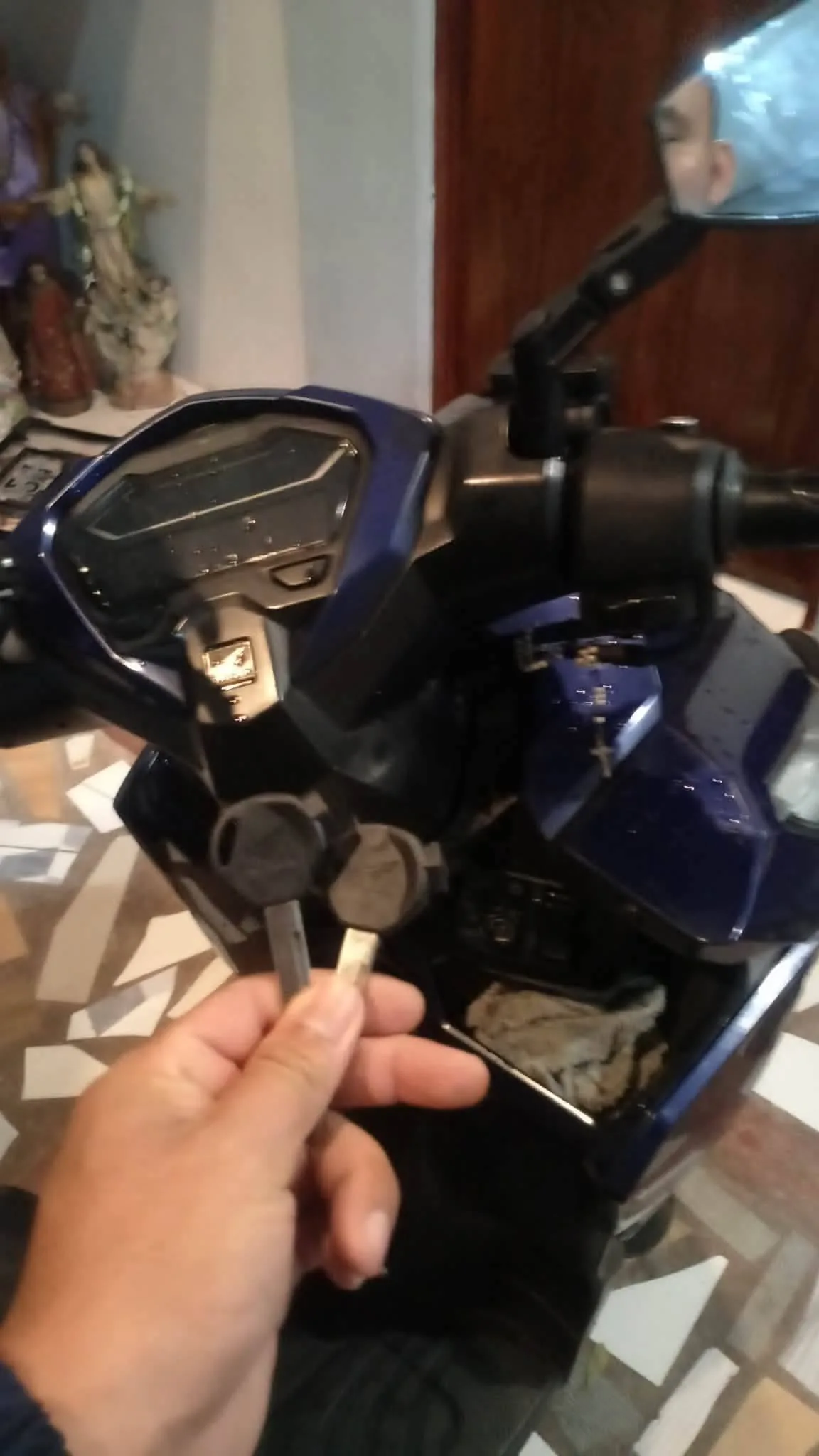 Locksmith holding a vehicle key fob during service